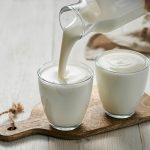 Pouring homemade kefir, buttermilk or yogurt